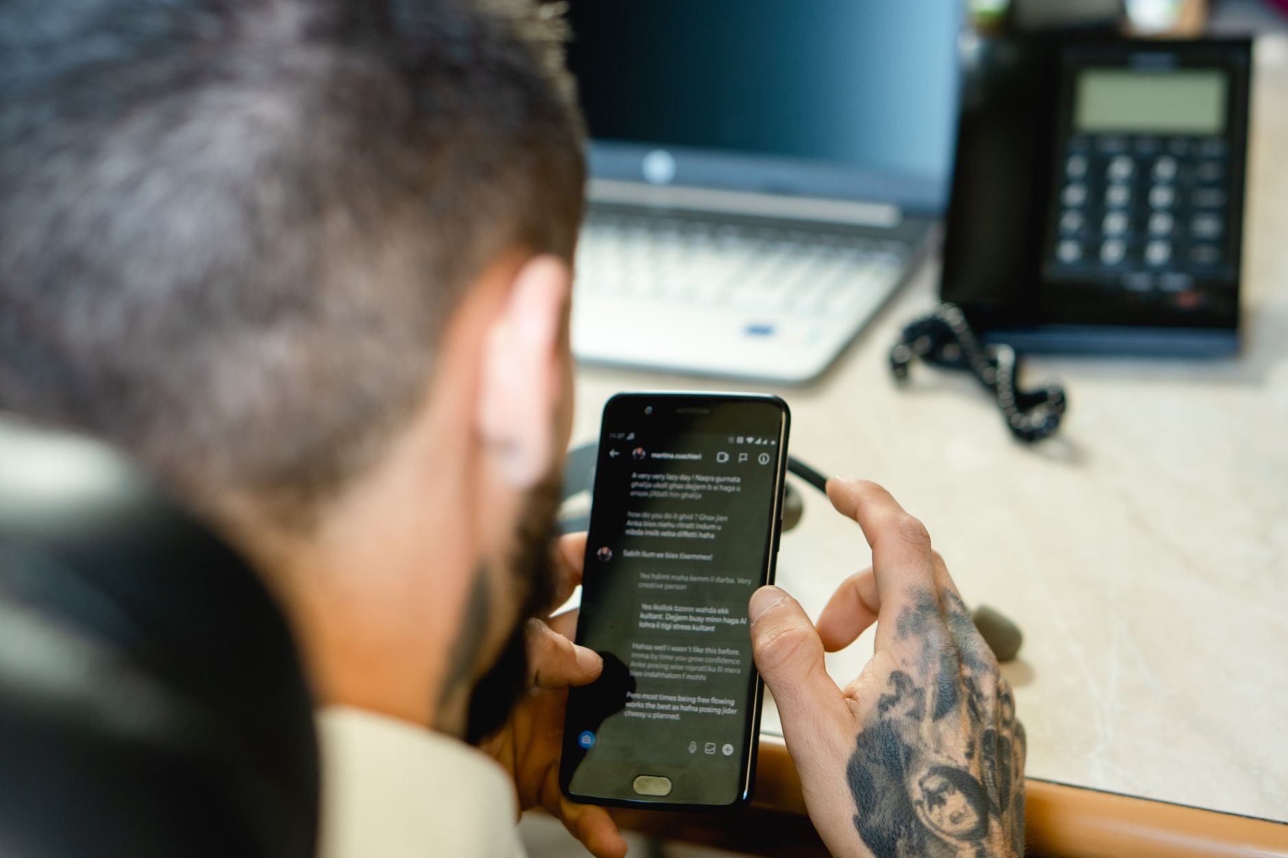 Profissional acessando informações via smartphone em ambiente de trabalho organizado
